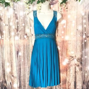 Cerulean blue satin type pleated low cut cocktail dress. Lace straps & waist.
